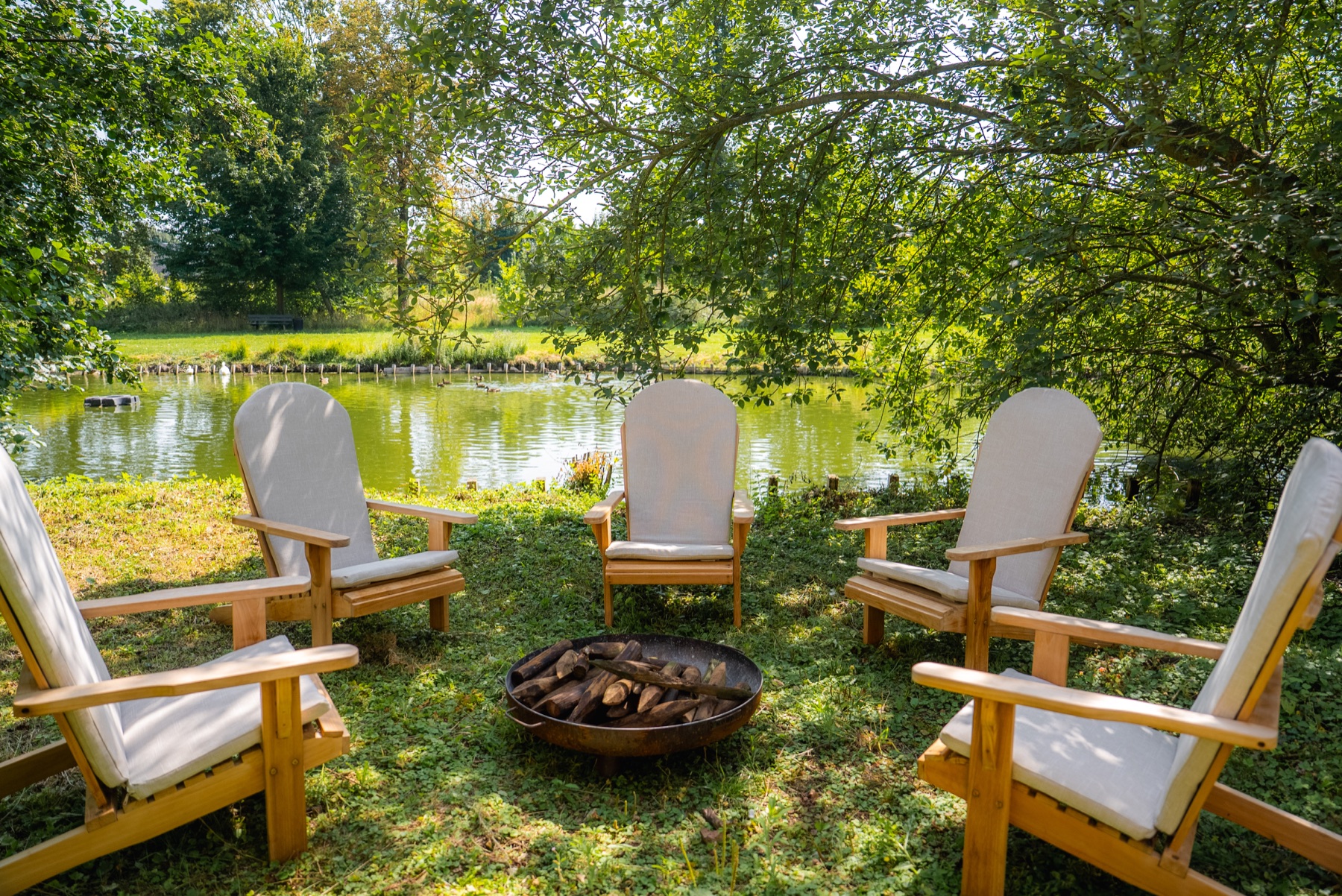 Chairs gathered beside the water on the estate