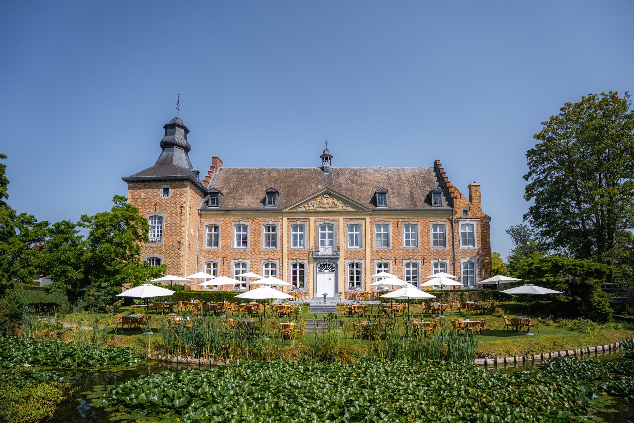 Historic facade and waterside terraces of Chateau de Looz