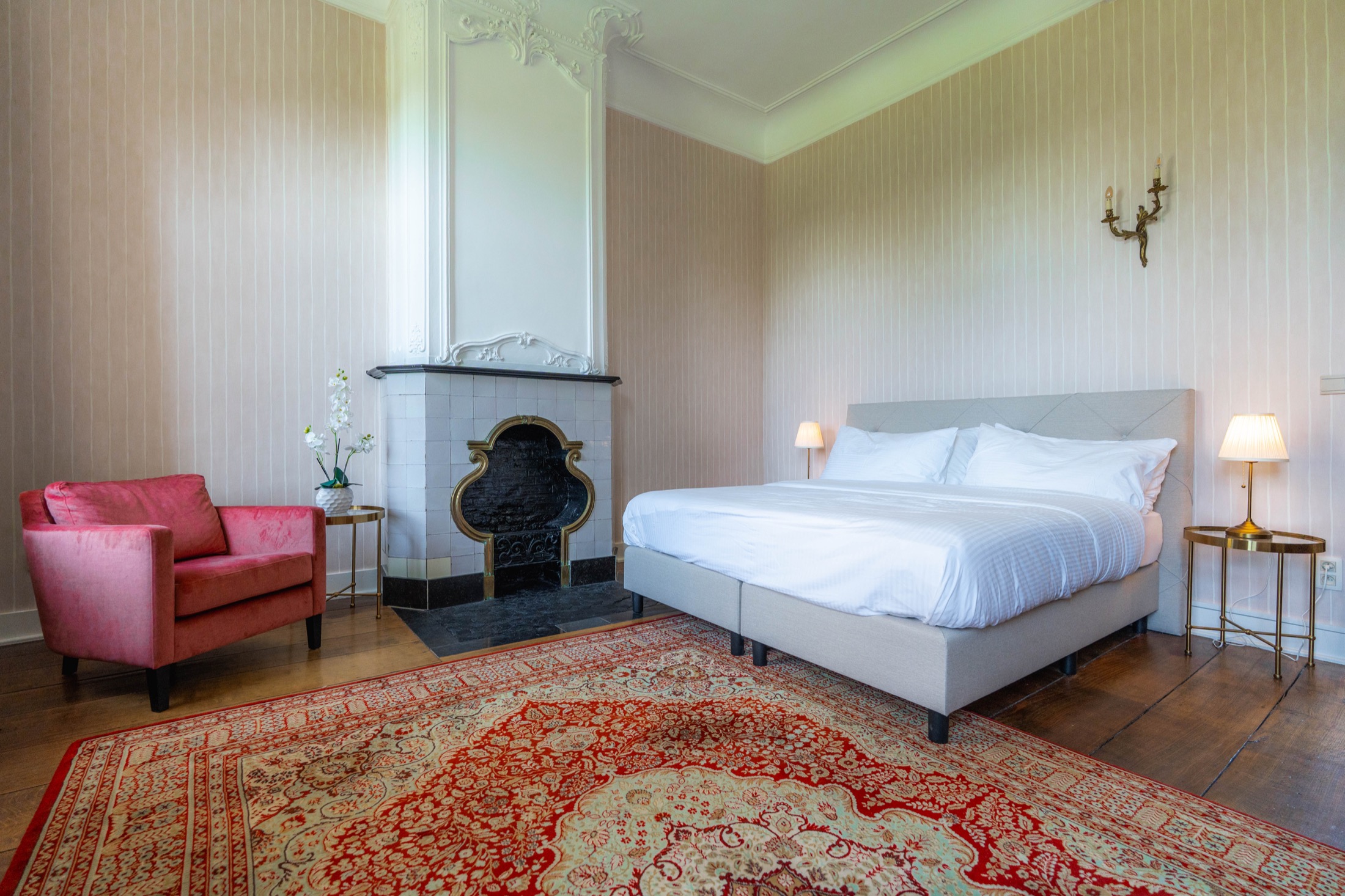 Historic guest room with fireplace and period details