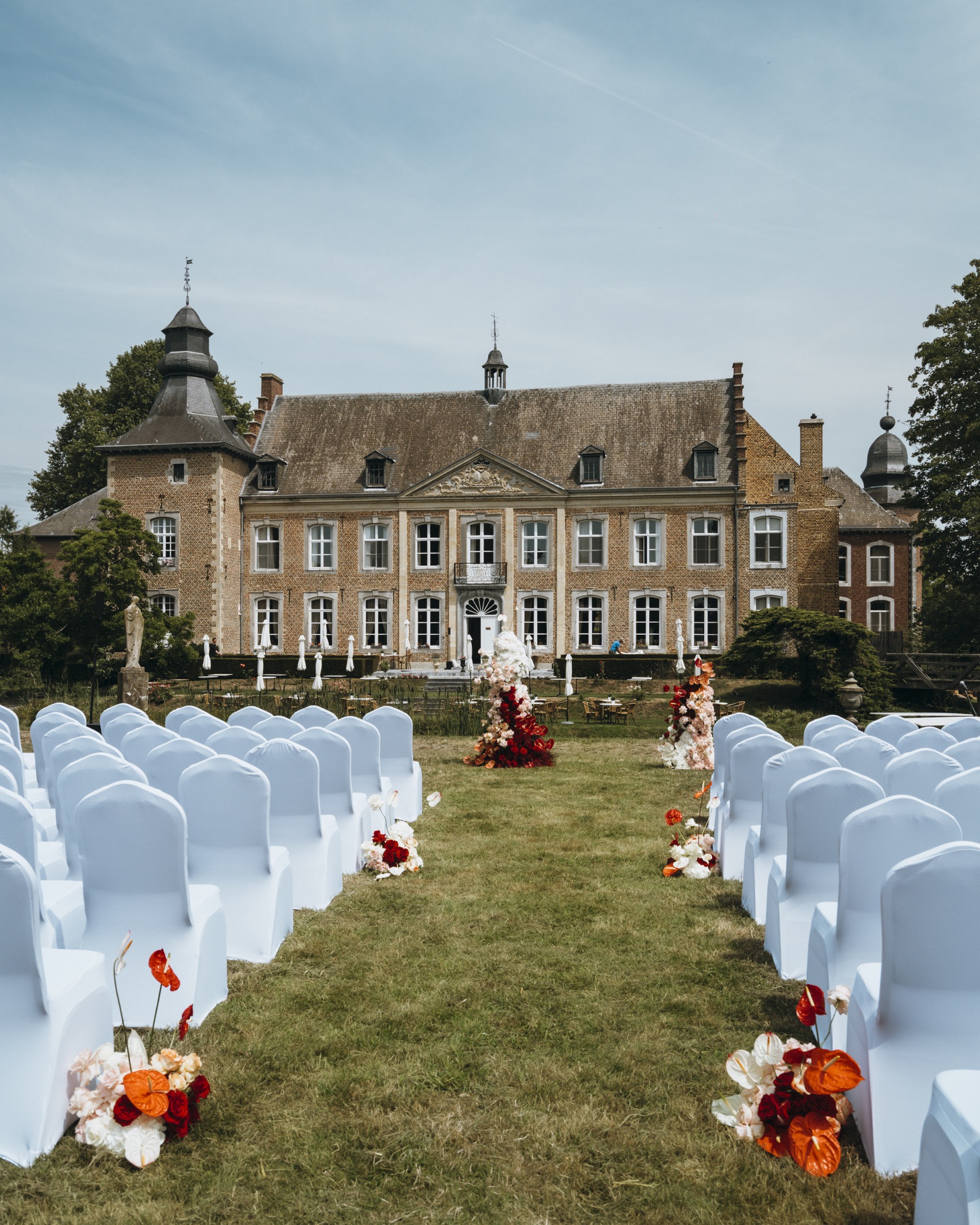Outdoor wedding ceremony setup in front of Chateau de Looz