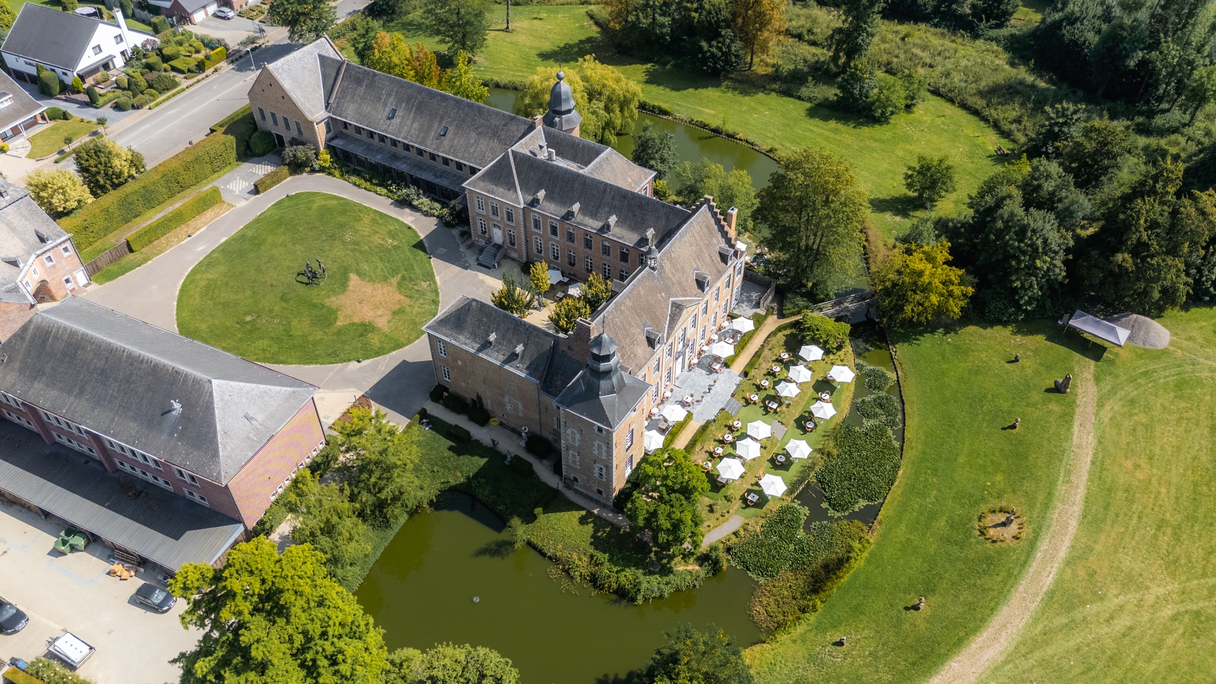 Aerial arrival view of Château de Looz and its grounds